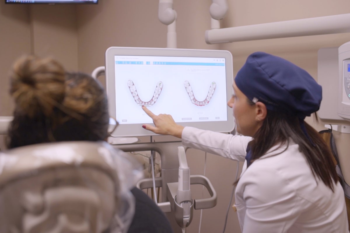 Dr. Bonifate showing a patient her dental X-rays at Bronxville dental office Bronxville Family Dental